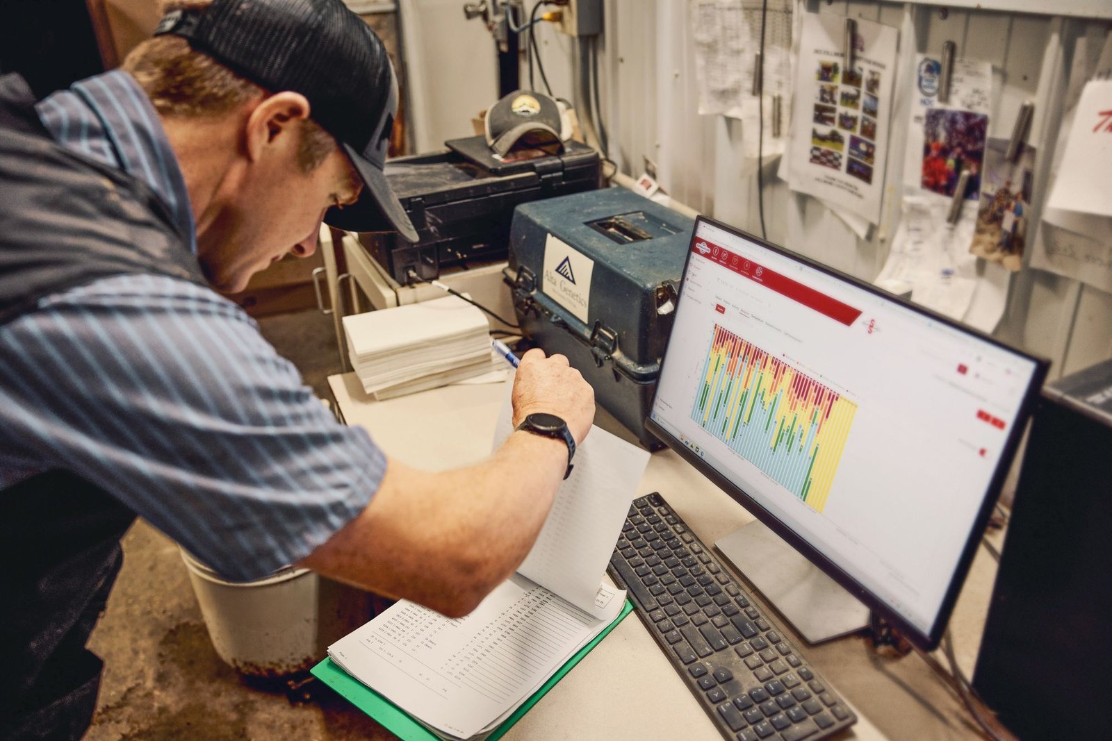 A business owner using management software in his workshop office